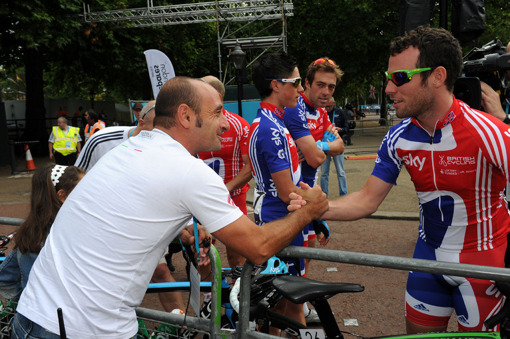 Italy's Olympic champion Paolo Bettini, left, looks at his