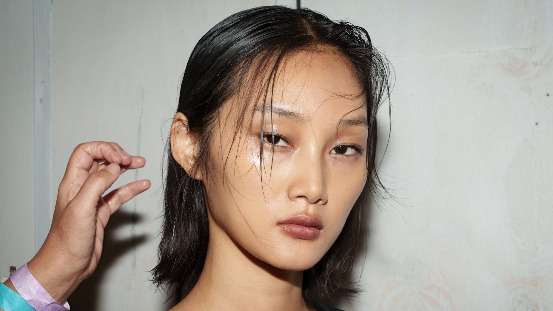 A model with shiny cheekbone highlighter.