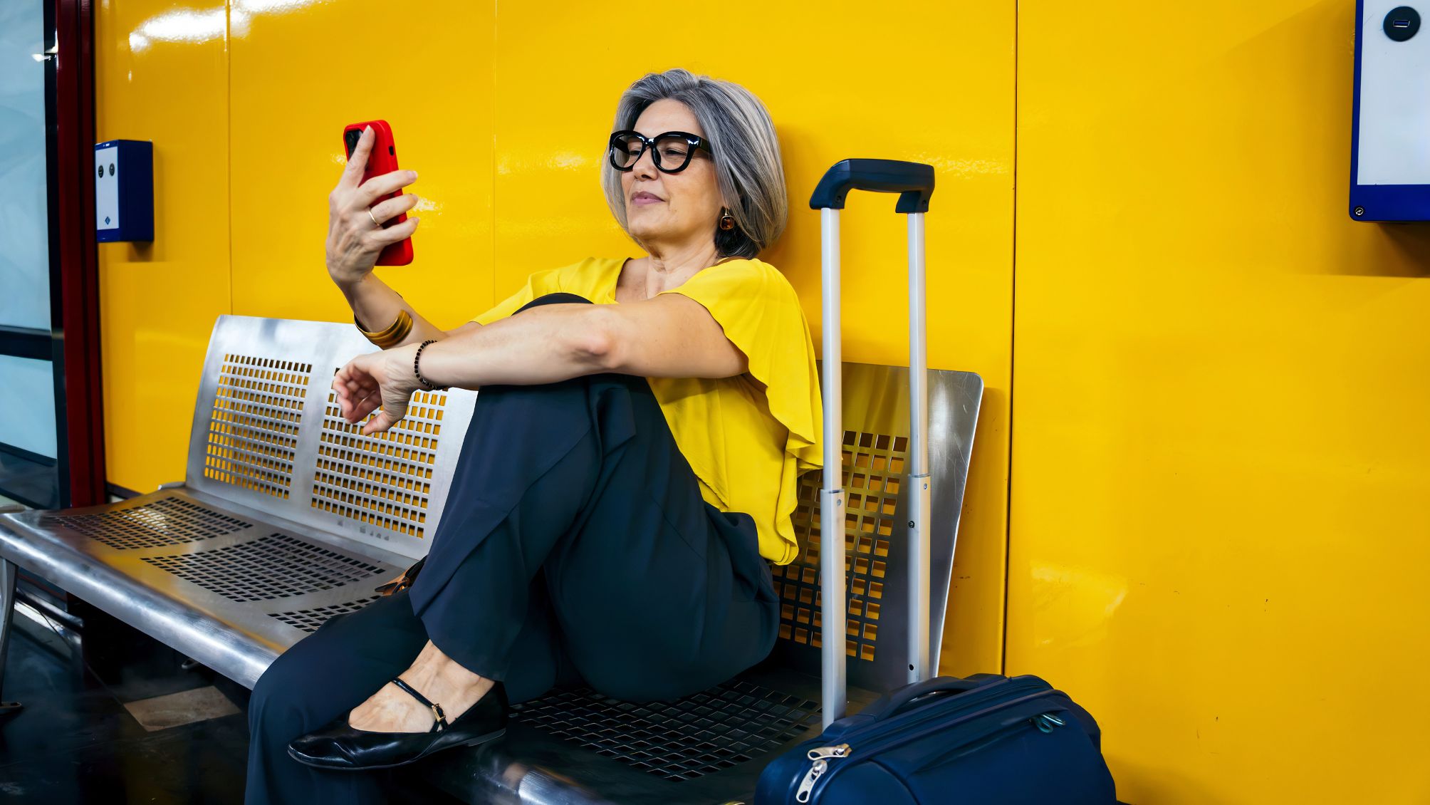 A woman checking her travel agenda, while waiting for departure. 