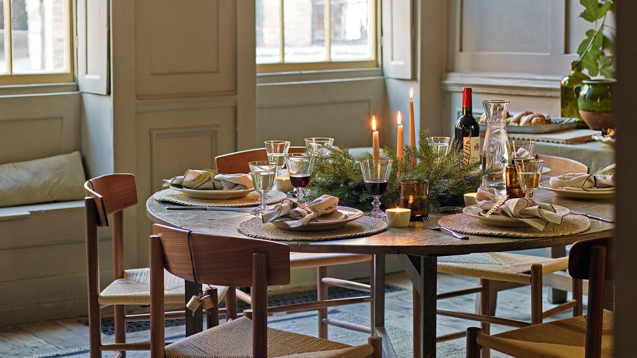 dining tabe in wood panelled room with candles and laid table