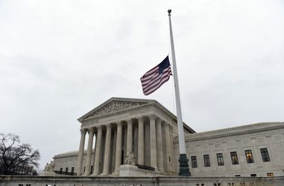 The flag flies at half-staff outside the Supreme Court in Washington, Tuesday, Feb. 16, 2016, following the death of Supreme Court Justice Antonin Scalia.