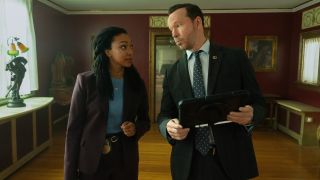Pictured (L-R): Sonequa Martin-Green as Lena Silver and Donnie Wahlberg as Danny Reagan looking at each other as Danny holds and iPad. 