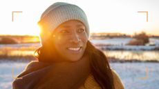 Smiling woman wearing hat, scarf and gloves against the snow, representing getting outside and learning how to boost your mood