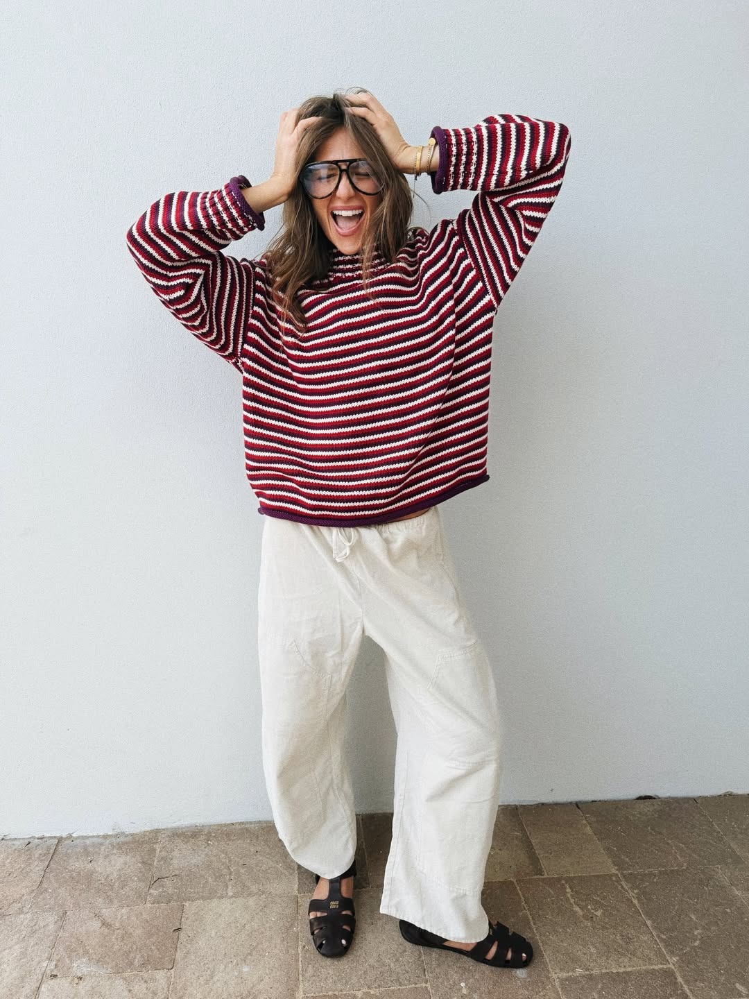 Woman in stripe rollneck and white linen pants