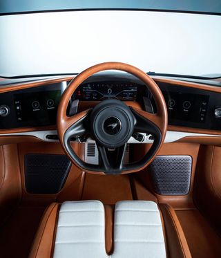 A steering wheel in brown leather in a sports car
