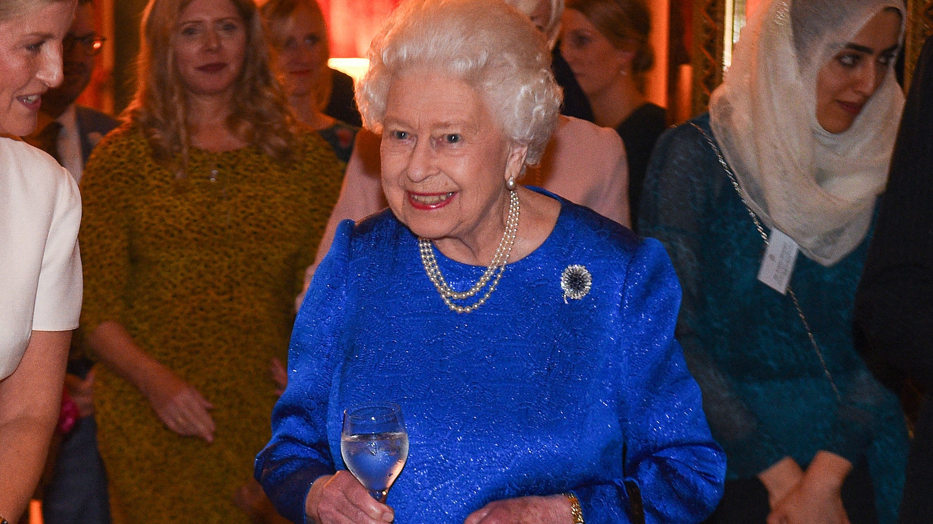 Queen Elizabeth holds a glass at a reception at Buckingham Palace in London on October 29, 2019