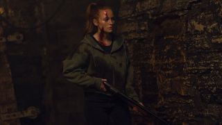 Madelaine Petsch carrying a shotgun in the strangers: chapter 3