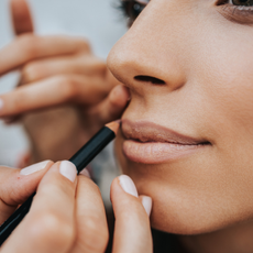 woman lipstick application - clinique nude honey