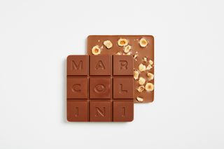 Pierre Marcolini Grand Cru square milk chocolate tablets with nuts and 'MARCOLINI' lettering