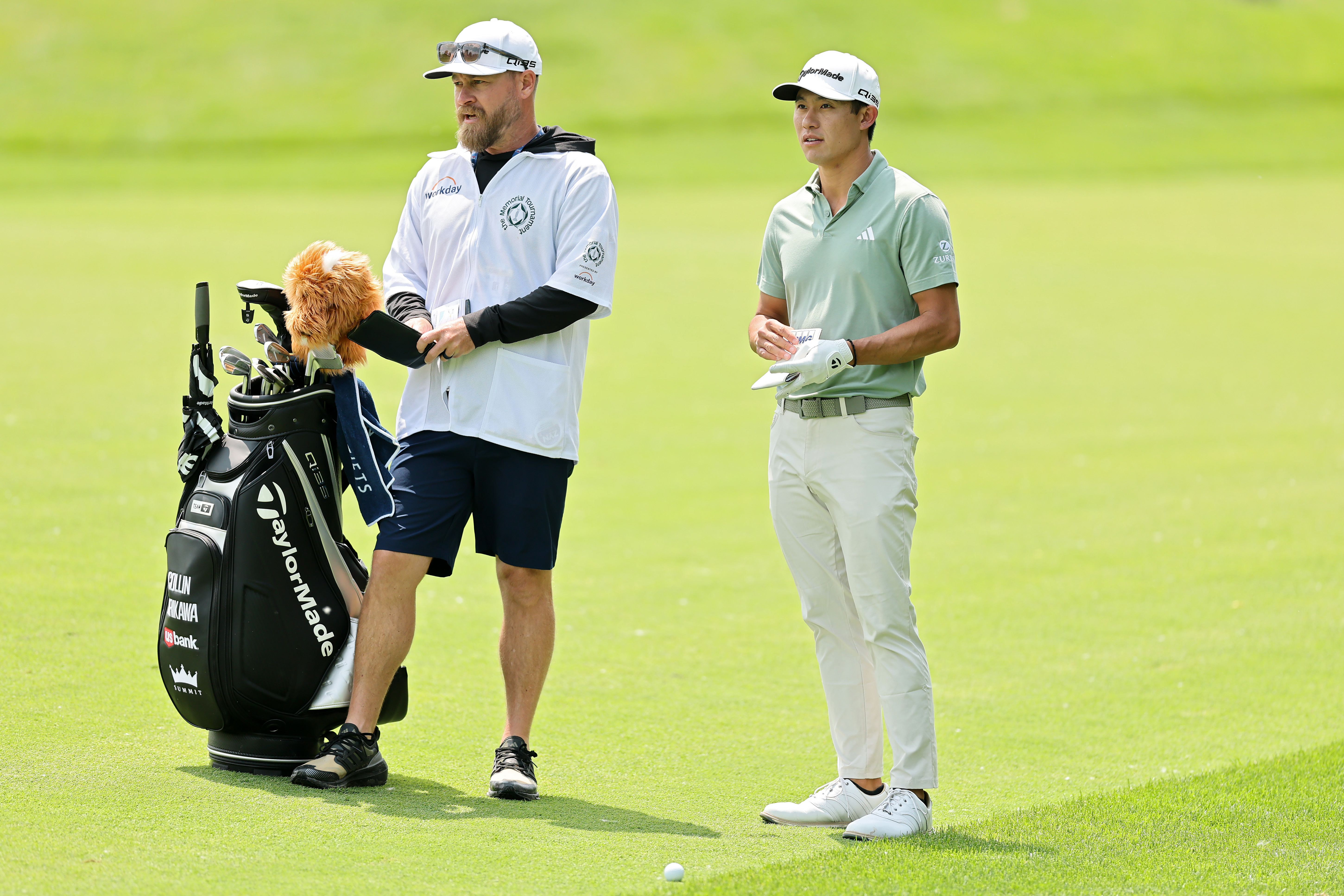 Collin Morikawa and his caddie chat during The Memorial Tournament