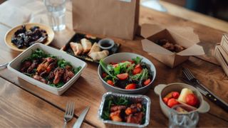A selection of meal delivery kits, including bowls of tomatoes and dumplings