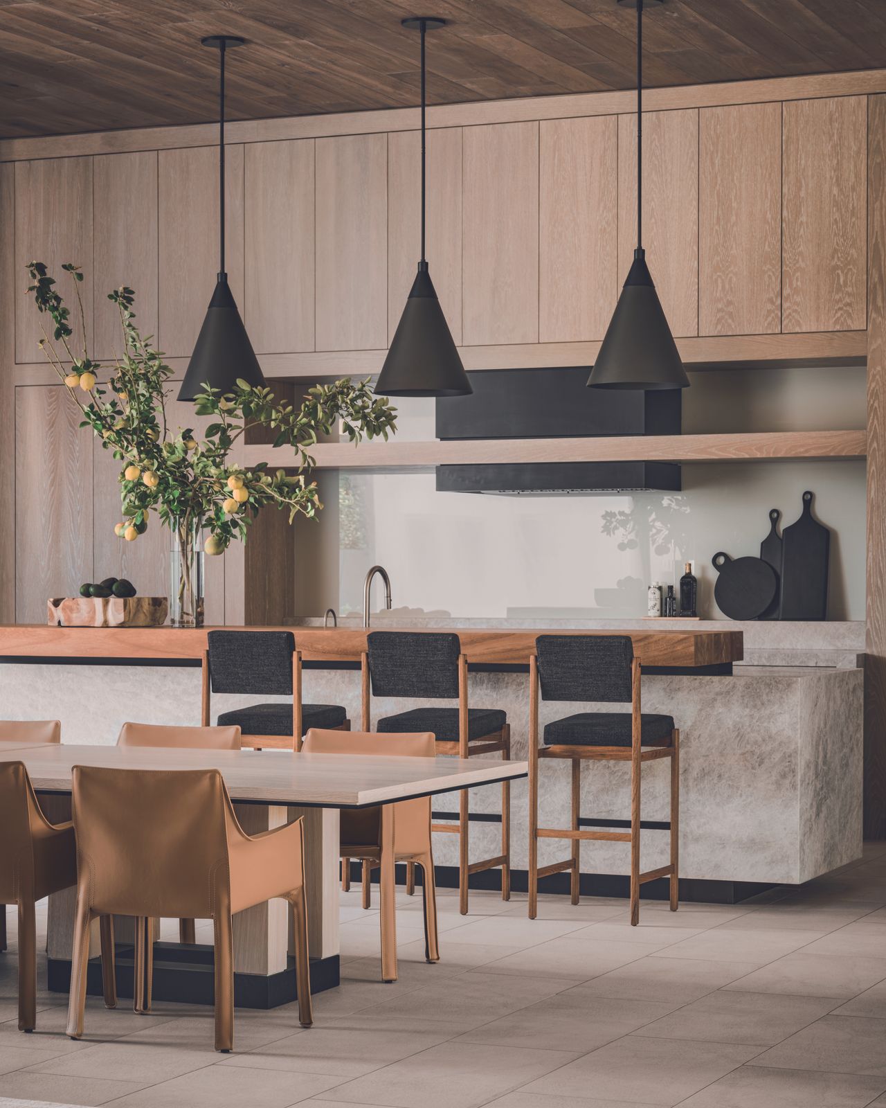 The kitchen and dining space, featuring a tranquil wooden ceiling and cupboard units with stone accents