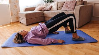 Woman doing glute bridge at home