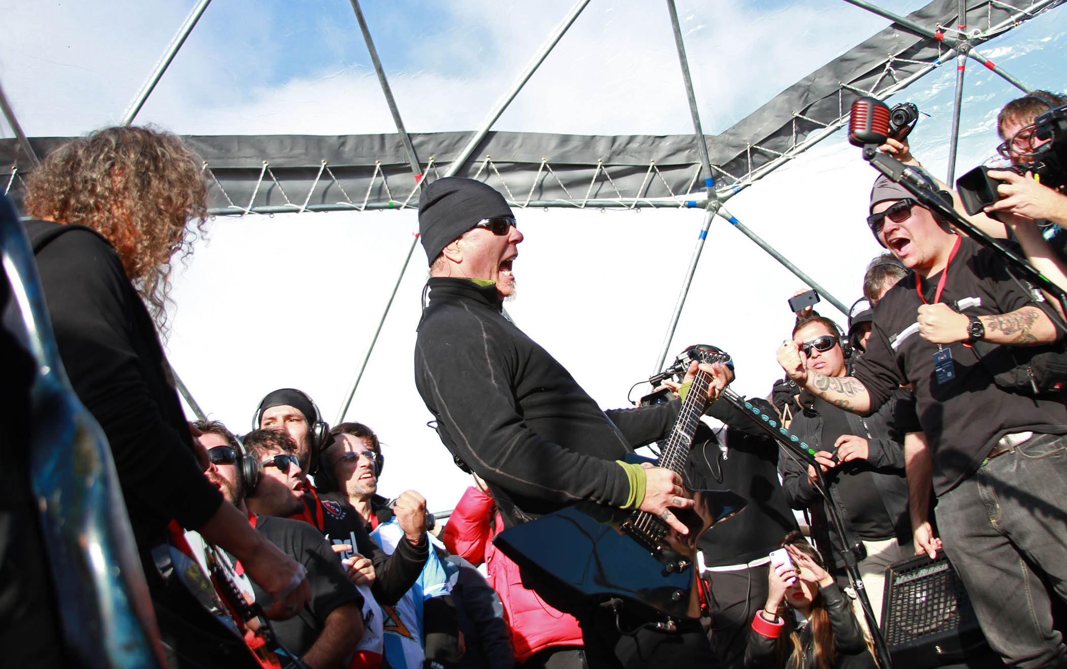 Metallica play to a crowd of fans wearing headphones at their legendary gig in Antarctica