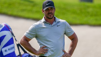 Brooks Koepka with his hands on his hips