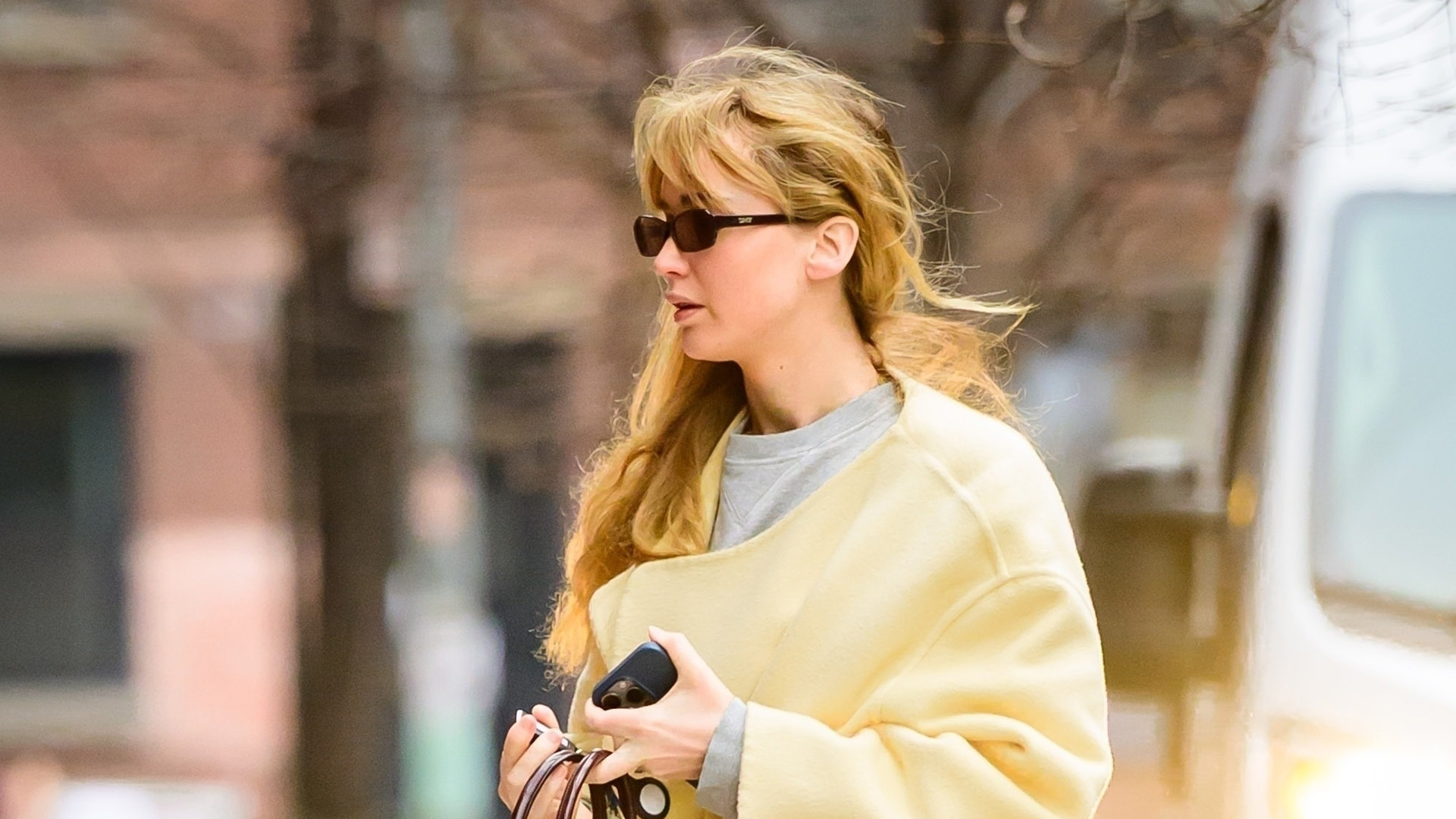 Jennifer Lawrence in yellow coat and ugg boots