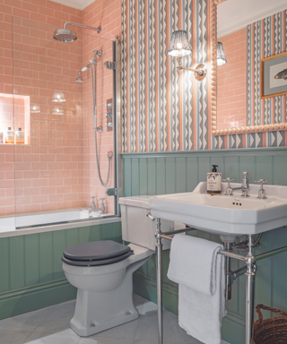 pink and green bathroom with patterned wallpaper
