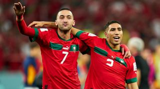 Hakim Ziyech and Achraf Hakimi of Morocco celebrate after the team's victory during the FIFA World Cup Qatar 2022 Round of 16 match between Morocco and Spain at Education City Stadium on December 06, 2022 in Al Rayyan, Qatar.