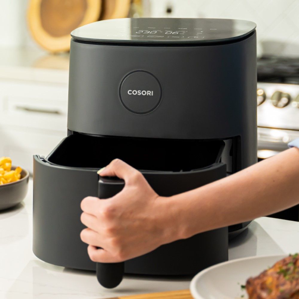 Person pulling out the drawer of the Cosori Air Fryer