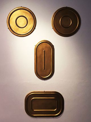 Gold trays arranged into a face
