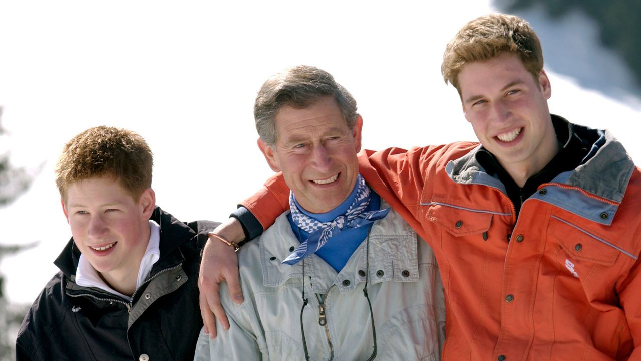 King Charles hugs sons Prince William and Prince Harry during a skiing trip