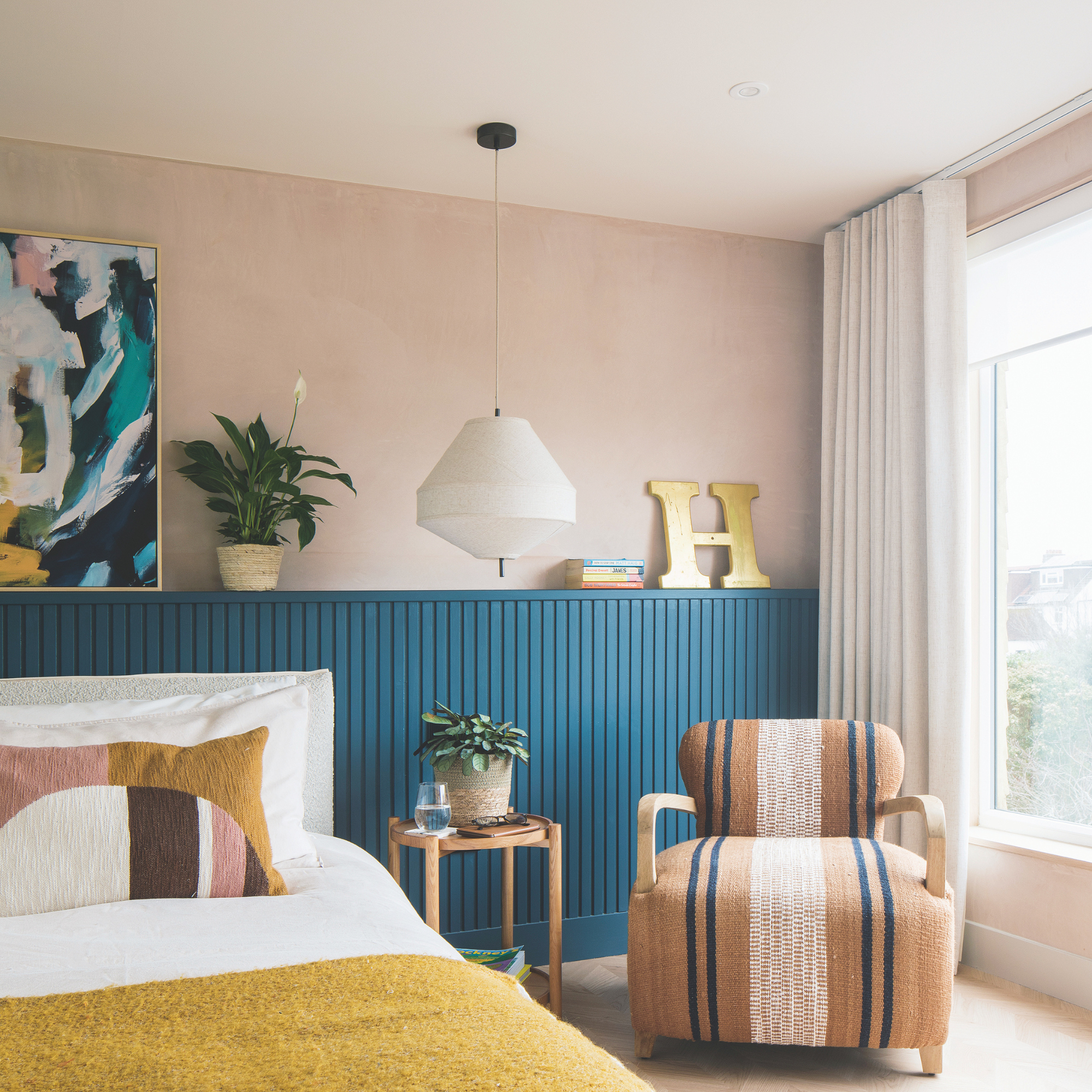 Dusky pink bedroom with blue panelling.