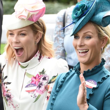 Zara Tindall and Autumn Kelly laughing at Royal Ascot and waving