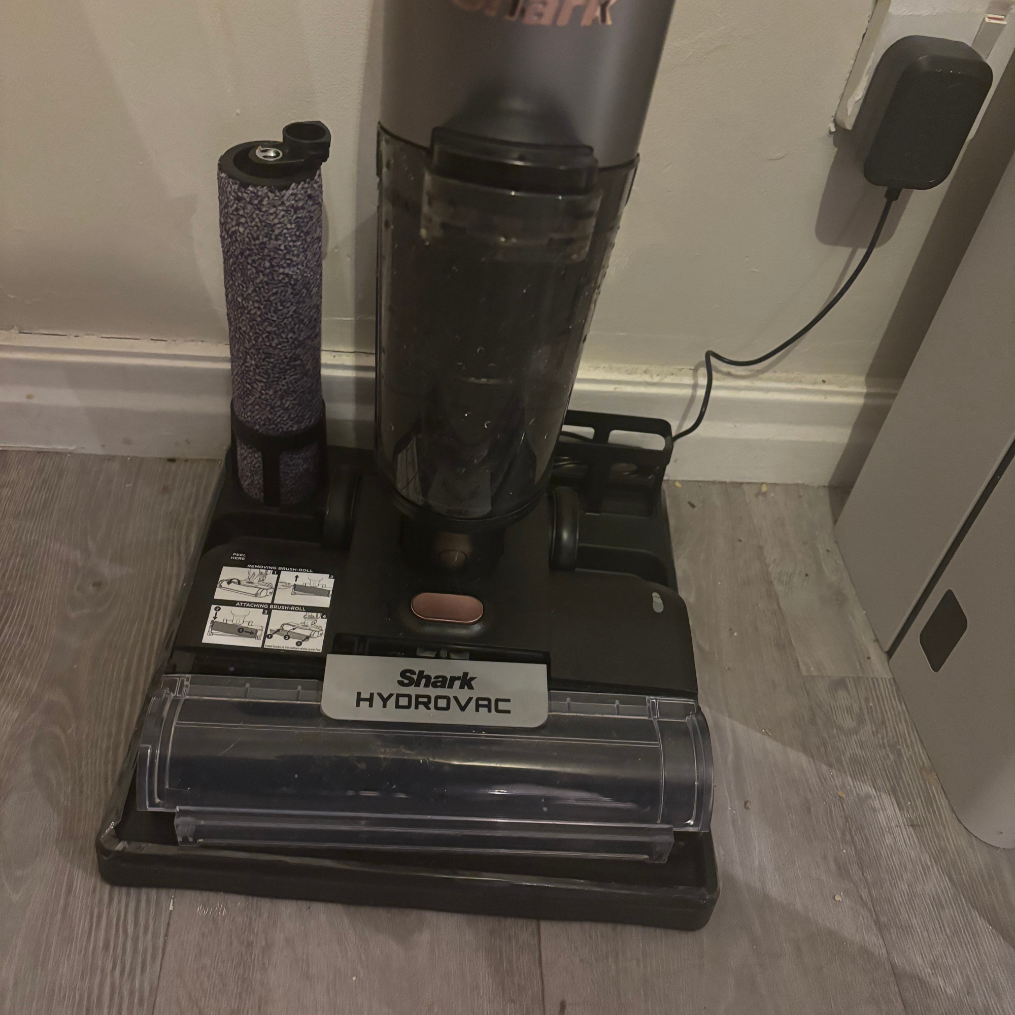 Shark HydroVac Cordless Hard Floor Cleaner on docking station with roller brush in holder