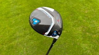 Cobra Aerojet Max Driver showing off its blue, red, black and white clubhead on the golf course