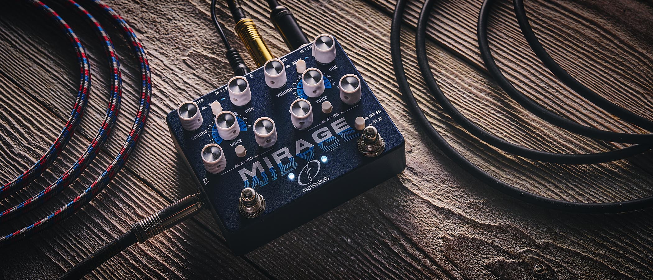 Crazy Tube Circuits Mirage: the all-singing all dancing new reverb unit has dual footswitches, 10 knobs, and is photographed against wooden flooring.