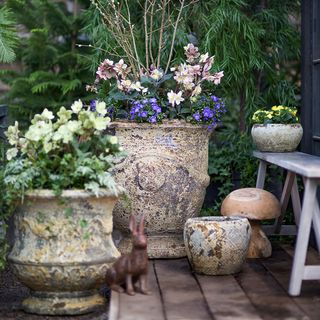 planters with flowers on a brick patio