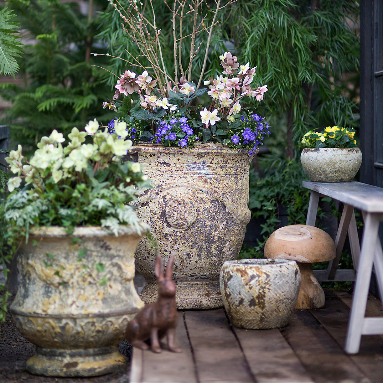 planters with flowers on a brick patio