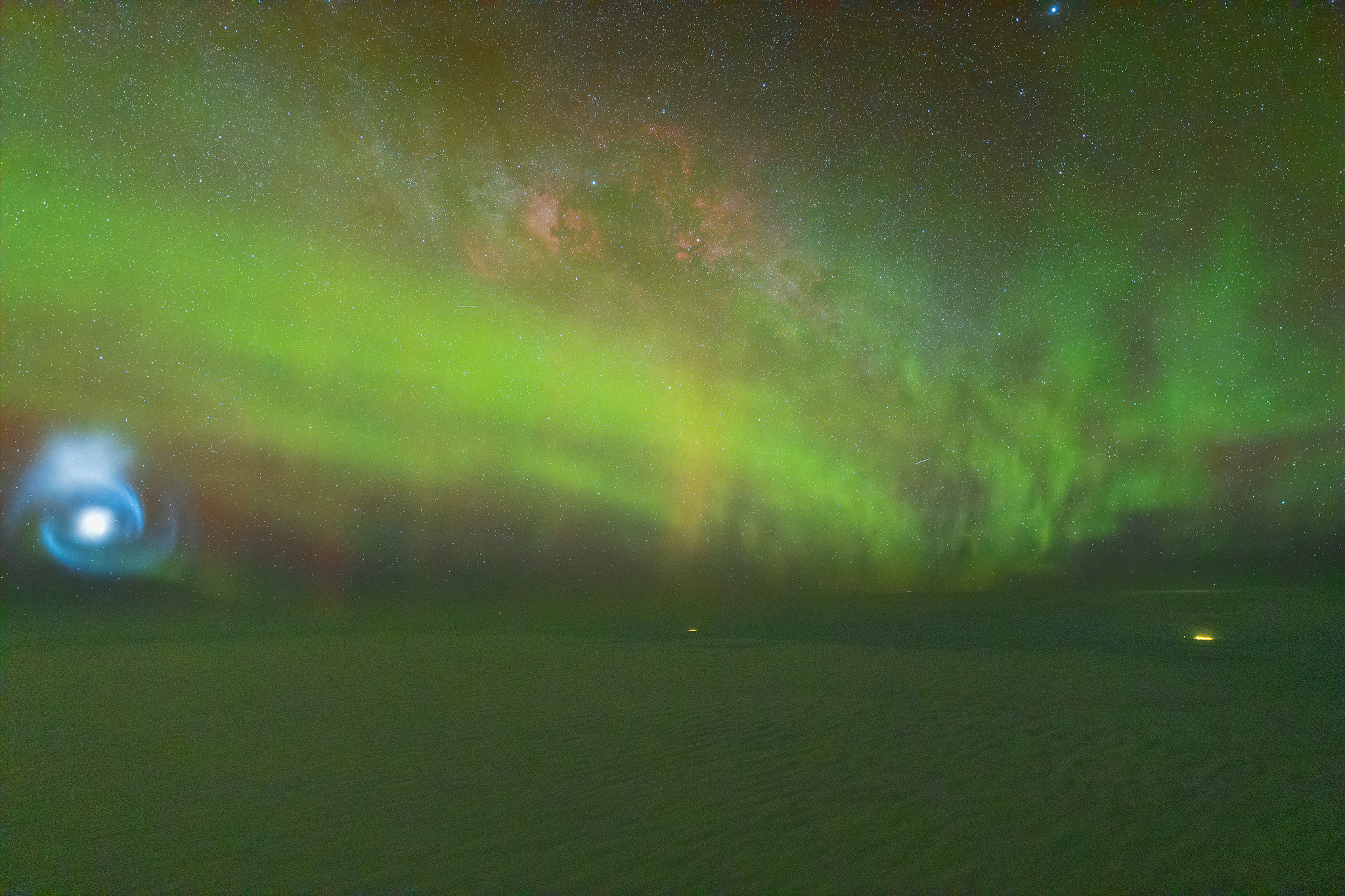 A photograph taken by pilot Ralf Rohner of the aurora and SpaceX Falcon fuel spiral above the clouds