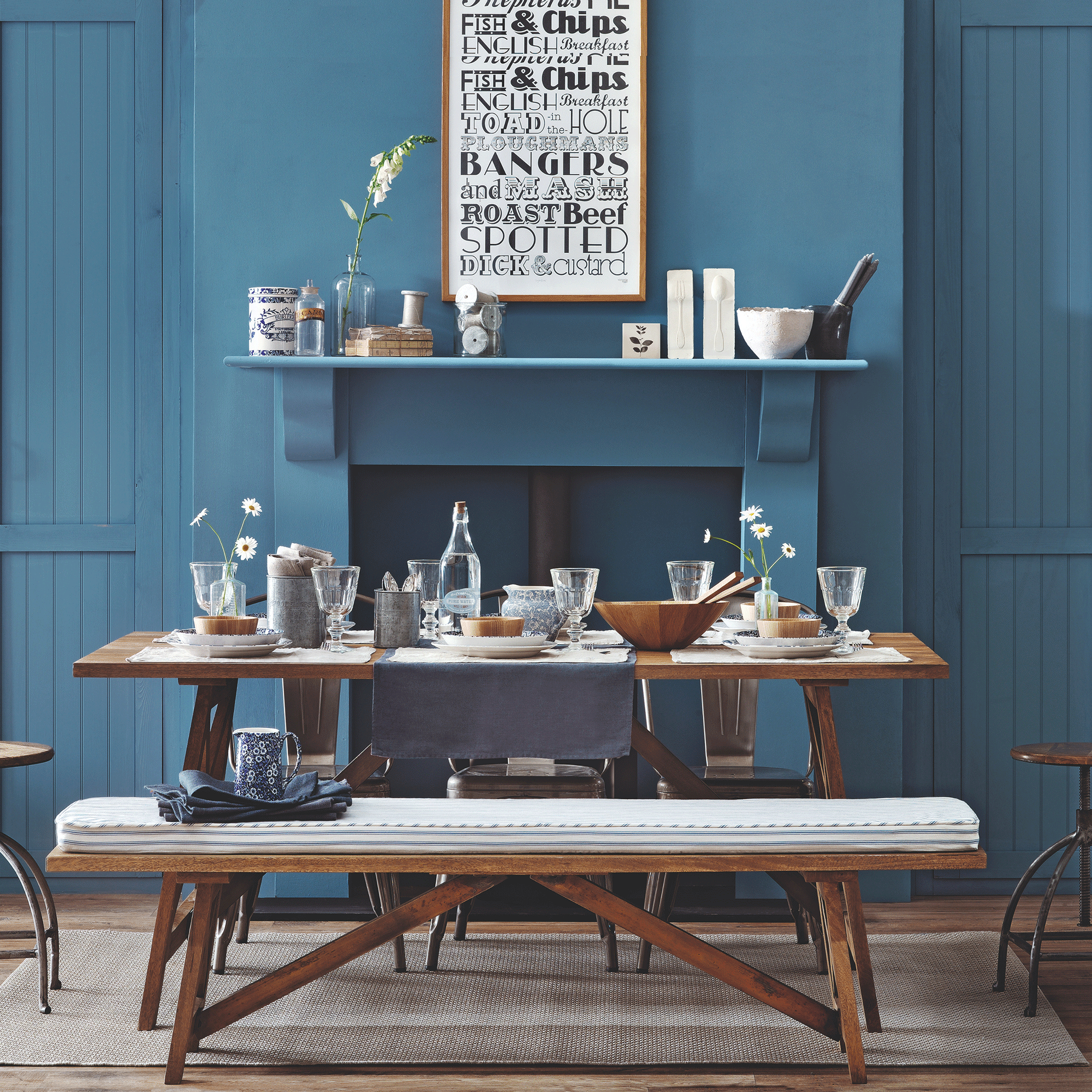 Blue dining room with fireplace and wooden table