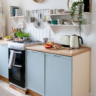 white kitchen with blue cupboard and worktop