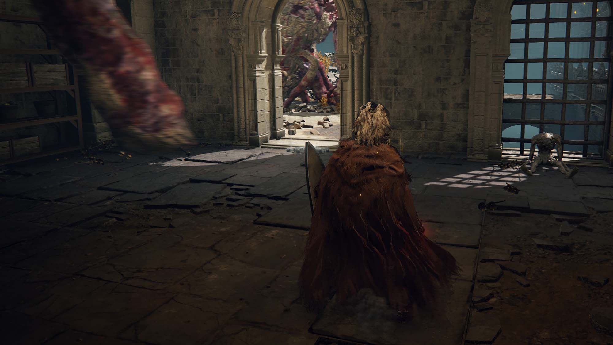 A putrid tree spirit that attacks a player through a wall in Elden Ring.