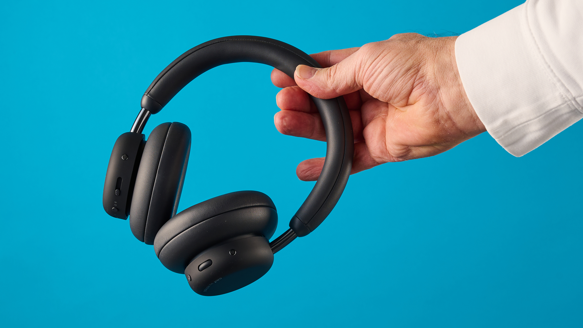 the cmf headphone pro / cmf by nothing headphone pro / nothing headphone pro in black photographed against a blue tom's guide background