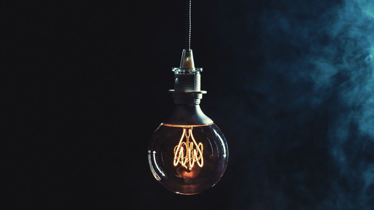 A lightbulb hanging in a dark room