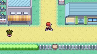 A screenshot from Pokemon FireRed and LeafGreen shows a male player character on a bike in a town.