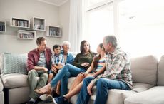 Shot of a three-generational family sitting together on a sofa at home