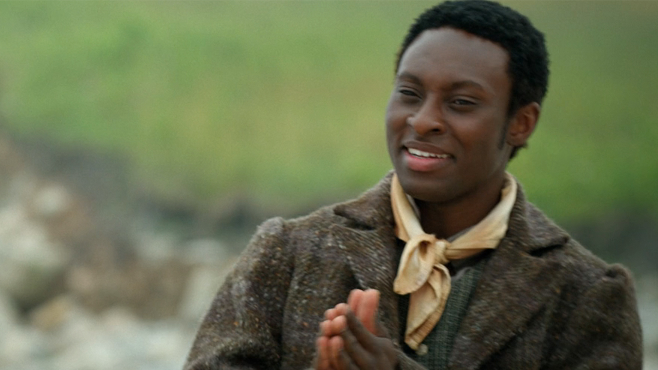 Ernest Kingsley Jr., smiling and holding his hands together in Washington Black