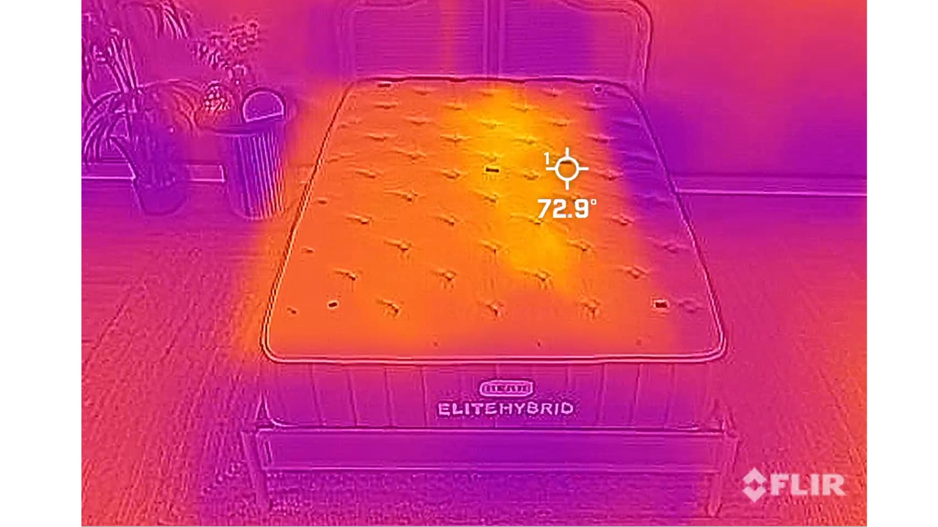 A thermal imaging camera image of the Bear Elite Hybrid mattress during the heat dispersion phase. While you can still see the outline of out tester on the right side of the mattress as a brighter yellow (indicating heat) it has faded significantly, making it harder to identify the outline of the person on the orange of the mattress.