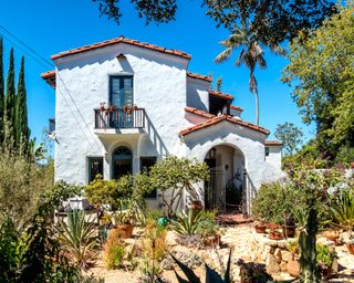 white Spanish colonial style house with red roof