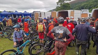 Riders loading bikes into vans at a MTB race