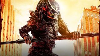 Close up image of Predator, a terrifying hunter humanoid-like alien with dark dreadlocks and sharp claws. They are holding a long spear and wearing armor, spikey shoulder pads and a helmet. They are standing on a street lined with tall buildings.