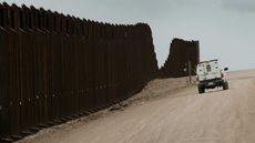 US Customs and Border Protection patrol a section of the existing border fence