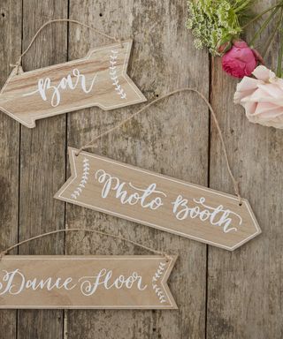 Vintage wooden signposts for different party areas