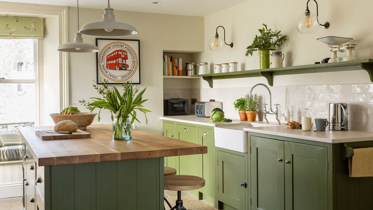 green kitchen in a country house with butlers sink and island