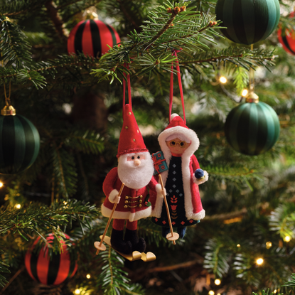 Mr and Mrs Claus hanging baubles