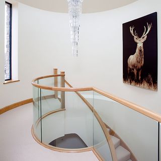 stairwell with wood and glass with beautiful chandelier